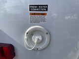 RV rental: fresh water connection and warning for potable tank sanitization, essential for safe use.
