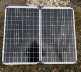 Portable, foldable Zamp Solar panels on grass. Essential for RV rental, off-grid charging, and camping.
