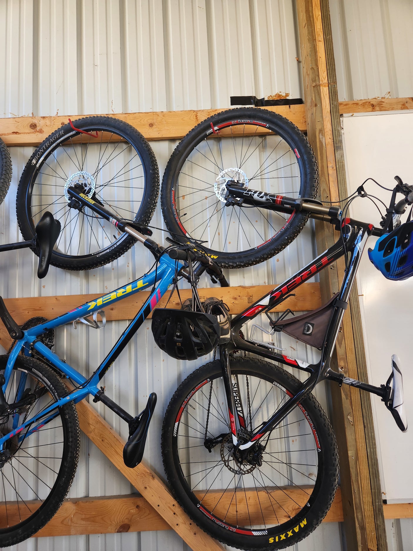 Mountain bikes and helmets organized on a garage wall, perfect for outdoor trips with an RV rental.