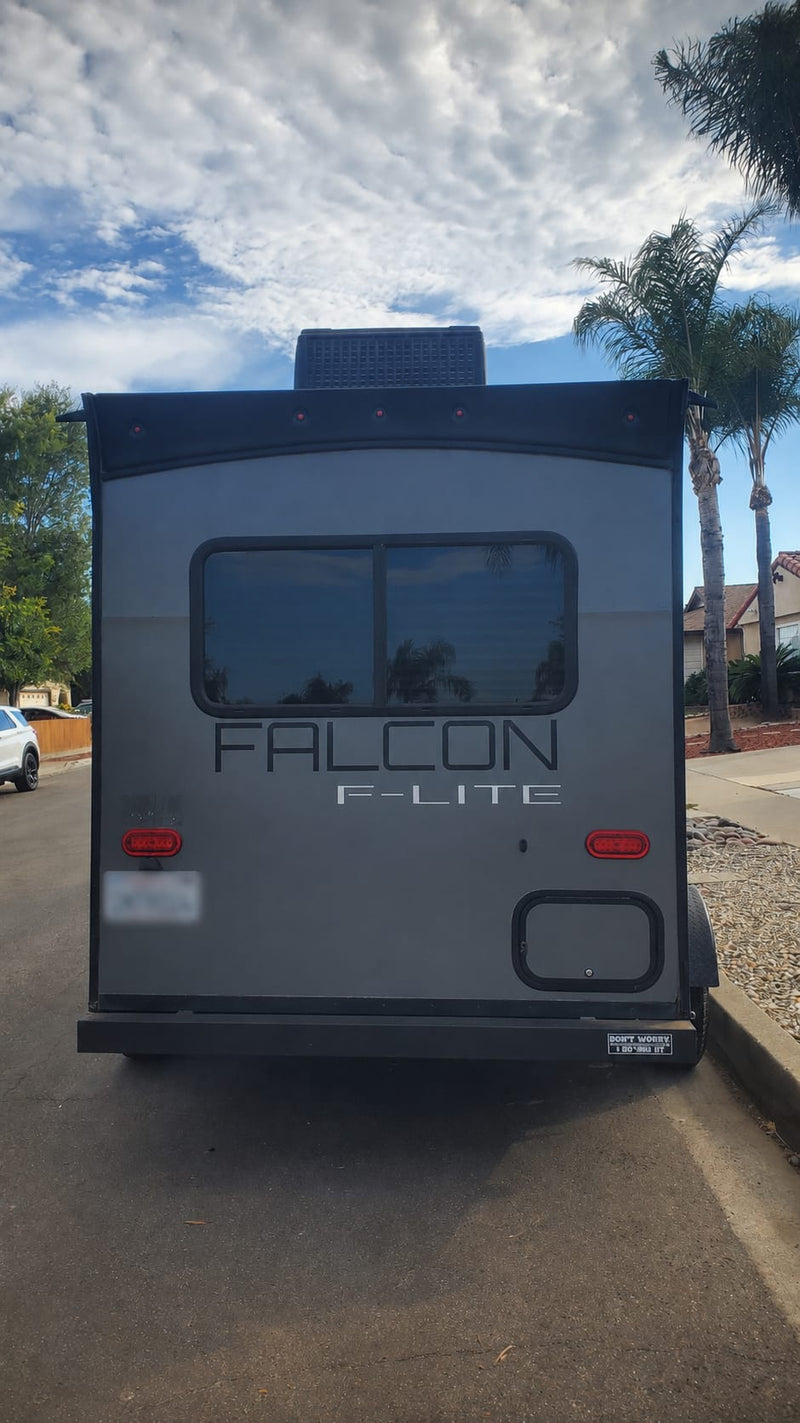  a compact RV rental unit. Rear view shows windows — photo 4