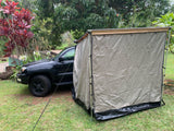 RV rental setup: Black SUV with an attached overlanding tent annex, perfect for vehicle camping in nature.
