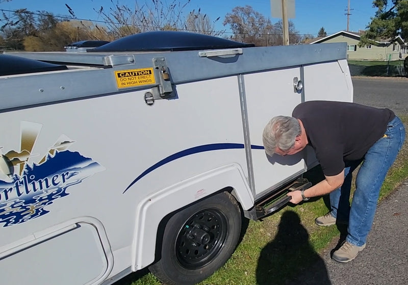  displaying a Washington license plate and a rear-mounted spare tire.|Bright A-frame rv rental interior showing a dining table — photo 2