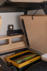 Optimized RV rental storage: Hidden compartment with a Kinjia stove in an InstaCrate & upper shelf for essentials.