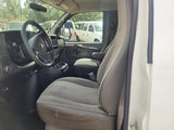 Driver's cockpit of a work van, possibly for rv rental. Shows steering wheel, dashboard, and front seats with wear.