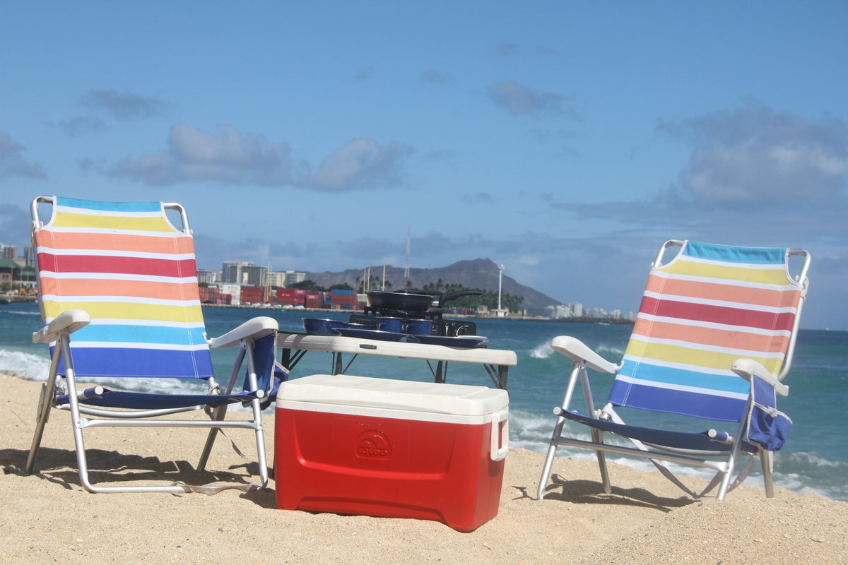 Sunny beach setup: two striped chairs, cooler, and portable cooking equipment by the ocean. Perfect for your RV rental outdoor escape. — photo 13