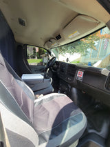 Interior of a practical vehicle cab, ideal for RV rental use. View from passenger seat shows dashboard, driver's area, and outside view.