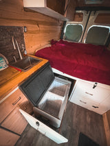 This inviting RV rental offers a compact kitchen, portable fridge, and full bed. Ideal for van life travel.