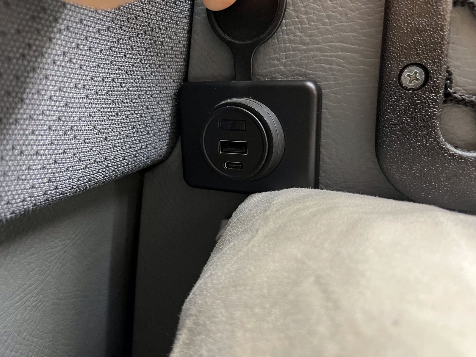 RV rental charging station: USB-A, USB-C, and a covered 12V outlet integrated into the vehicle interior.