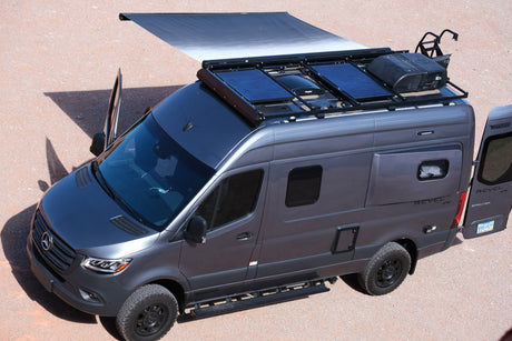 Gray Mercedes-Benz Sprinter Winnebago Revel RV with solar panels, roof AC, and extended awning. Ideal for an rv rental adventure.