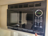 Black High Pointe microwave, built into an RV rental. Features a digital clock and multiple cooking options for travel convenience.