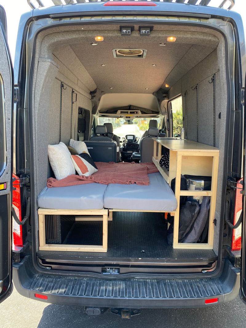 Spacious camper van interior, perfect for your next RV rental adventure. Features bed, kitchen, & ample storage. — photo 9