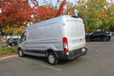A gray Ford E-Transit van is parked in an autumn lot. Its spacious interior makes it a potential candidate for an rv rental conversion.