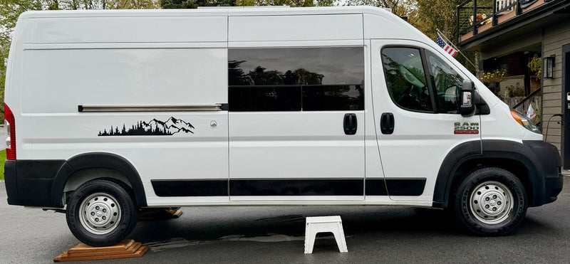 Side view of a white Ram ProMaster rv rental camper van, featuring a scenic mountain decal and tinted windows. — photo 6