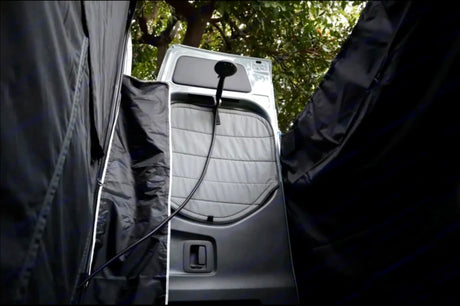 RV rental: Portable outdoor shower at vehicle rear, with black privacy enclosure. Ideal for camping.
