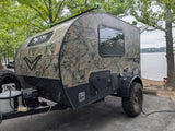 This rugged camouflage Sunray teardrop RV rental, perfect for lake camping, is powered up for adventure.