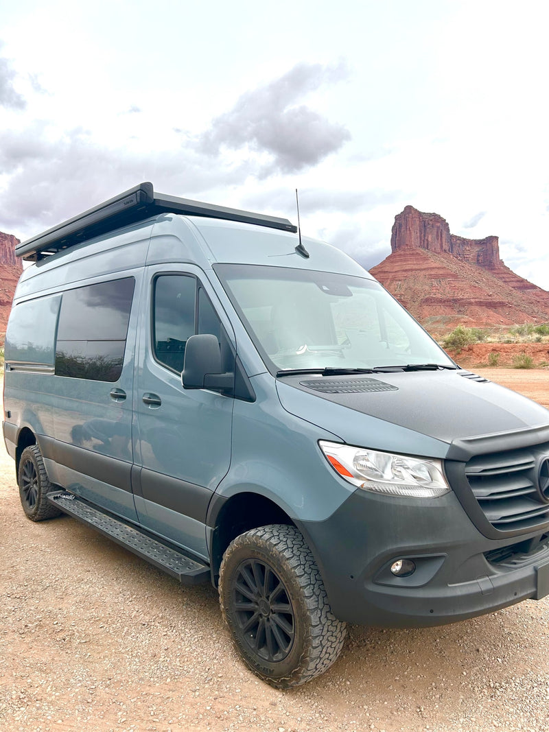 Adventure Sprinter RV rental on a dirt road, with stunning red rock formations in the background. — photo 3