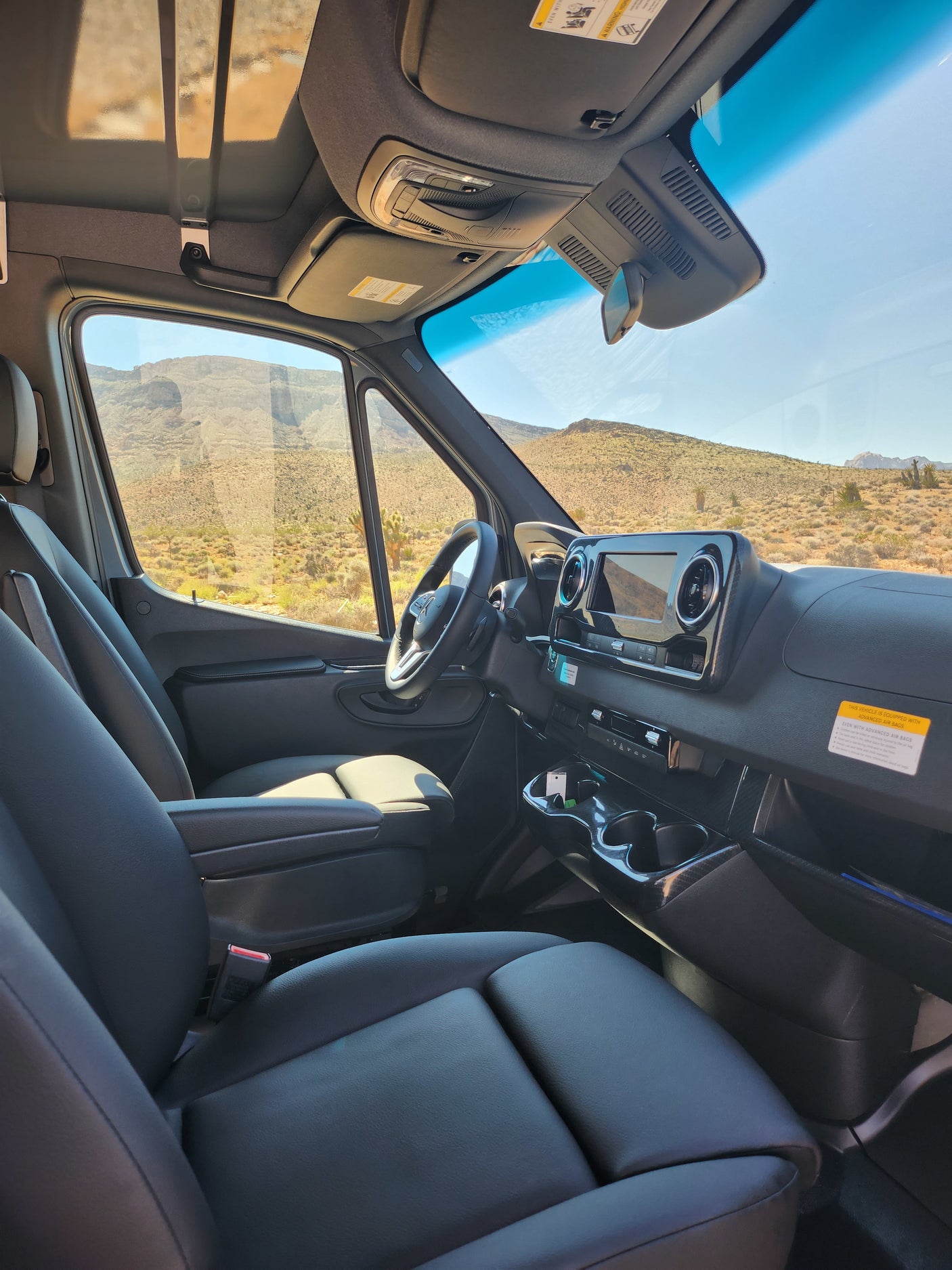 Spacious RV rental interior from passenger side. Shows driver's