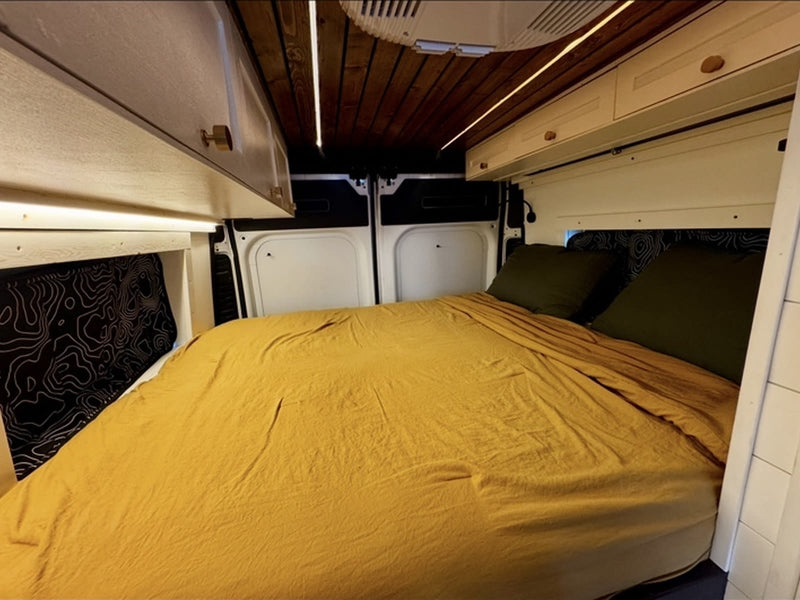  ready for your next adventure.|This RV rental showcases a cozy bed — photo 7
