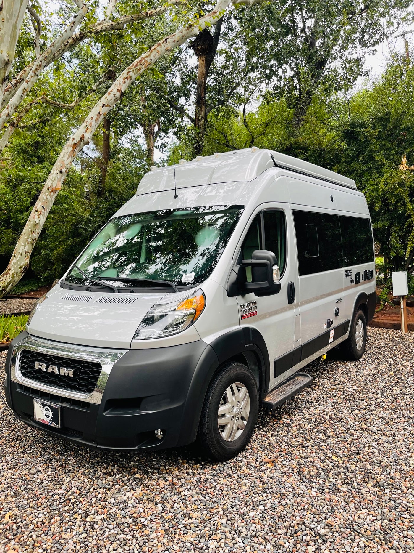  ready for adventure.|RV rental ready for adventure: white camper van with open door showing interior amenities. Outdoor table — photo 2