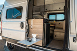 Inside this RV rental, discover a cleverly designed interior: outdoor coffee table, kitchen, fridge & convertible seating.