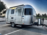 Discover adventure with this Airstream rv rental! A gleaming silver travel trailer parked outdoors, ready for your next journey.