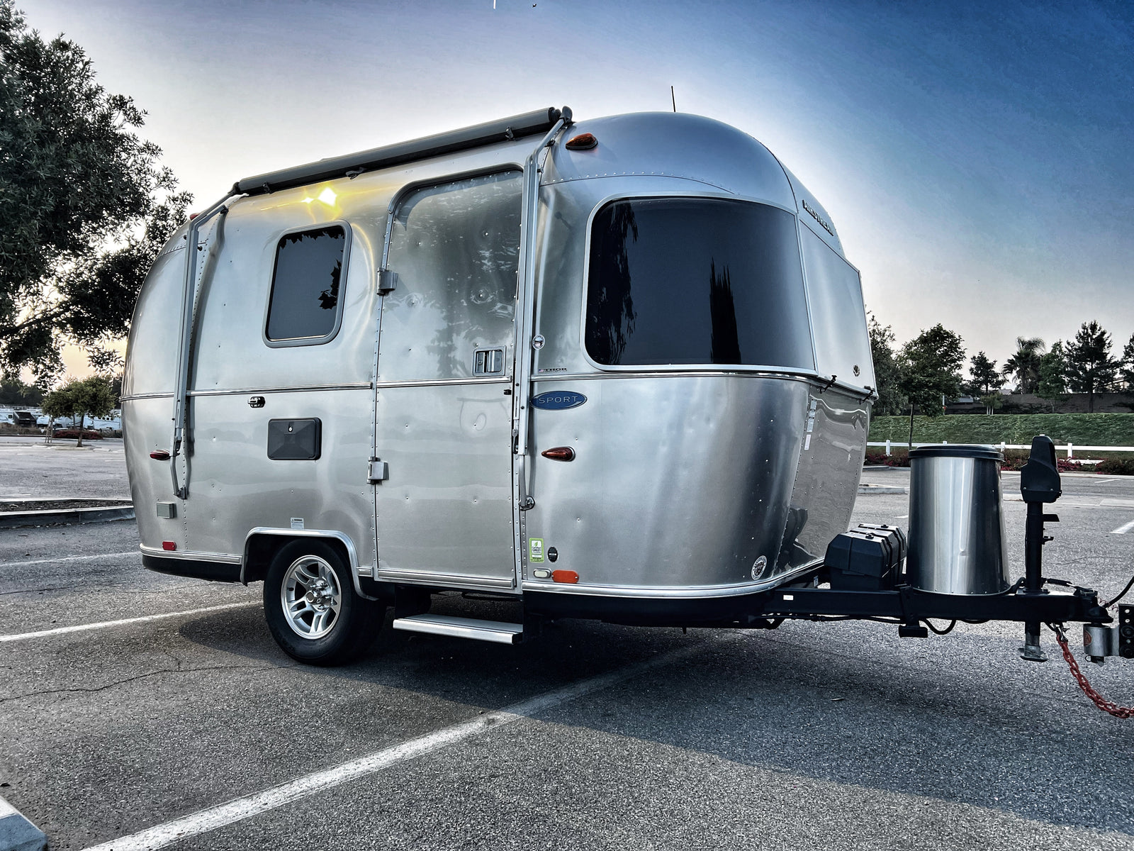 Discover adventure with this Airstream rv rental! A gleaming silver travel trailer parked outdoors, ready for your next journey.