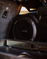 RV rental interior: Alpine subwoofer, custom pull-out drawer, and child seat TOP TETHER for comfort and safety on the road.