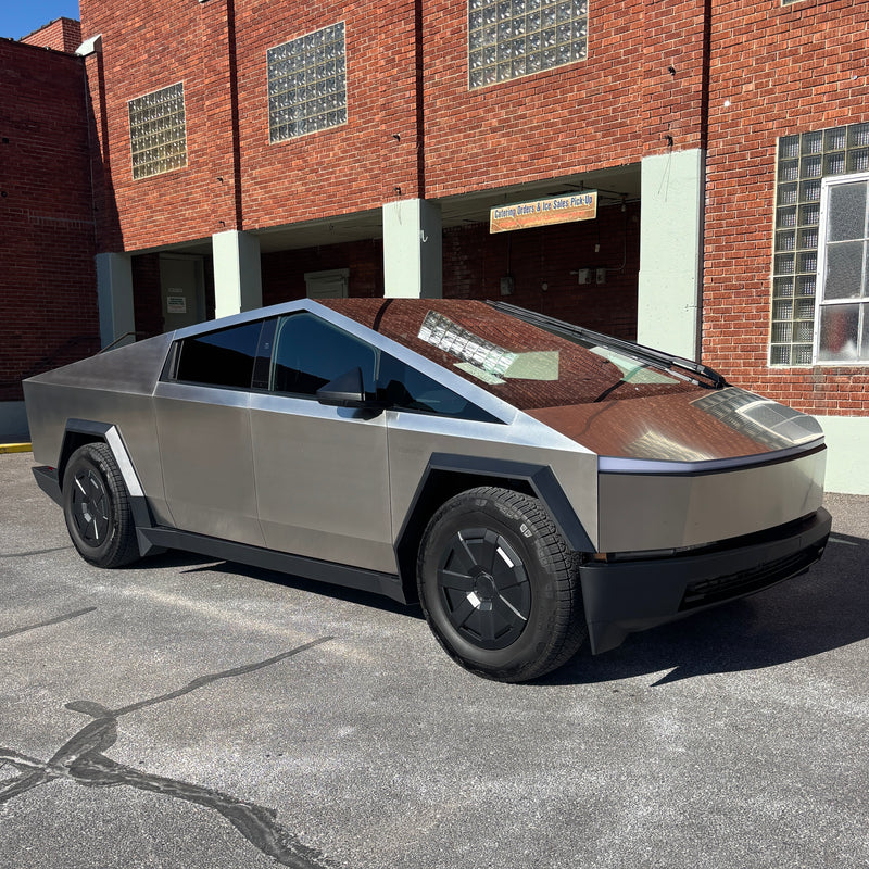 A bold Tesla Cybertruck, its angular design reflecting a brick building, parked outdoors. A striking, electric alternative to an RV rental. — photo 5