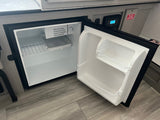 Inside an RV, an open Everchill mini-fridge reveals its thermostat and safety warnings, perfect for an rv rental.