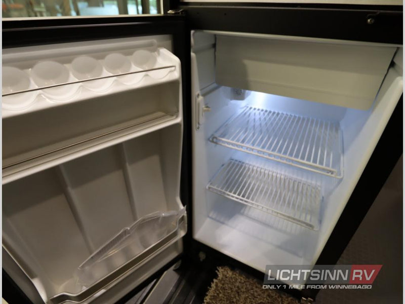  covered by a transparent bug screen.|Bright rv rental interior with kitchen sink — photo 5