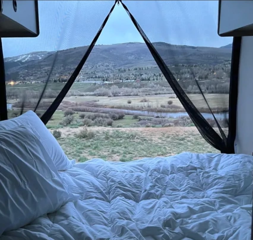 Wake up to stunning mountain & river views in this cozy RV rental! Perfect for nature lovers and travel.