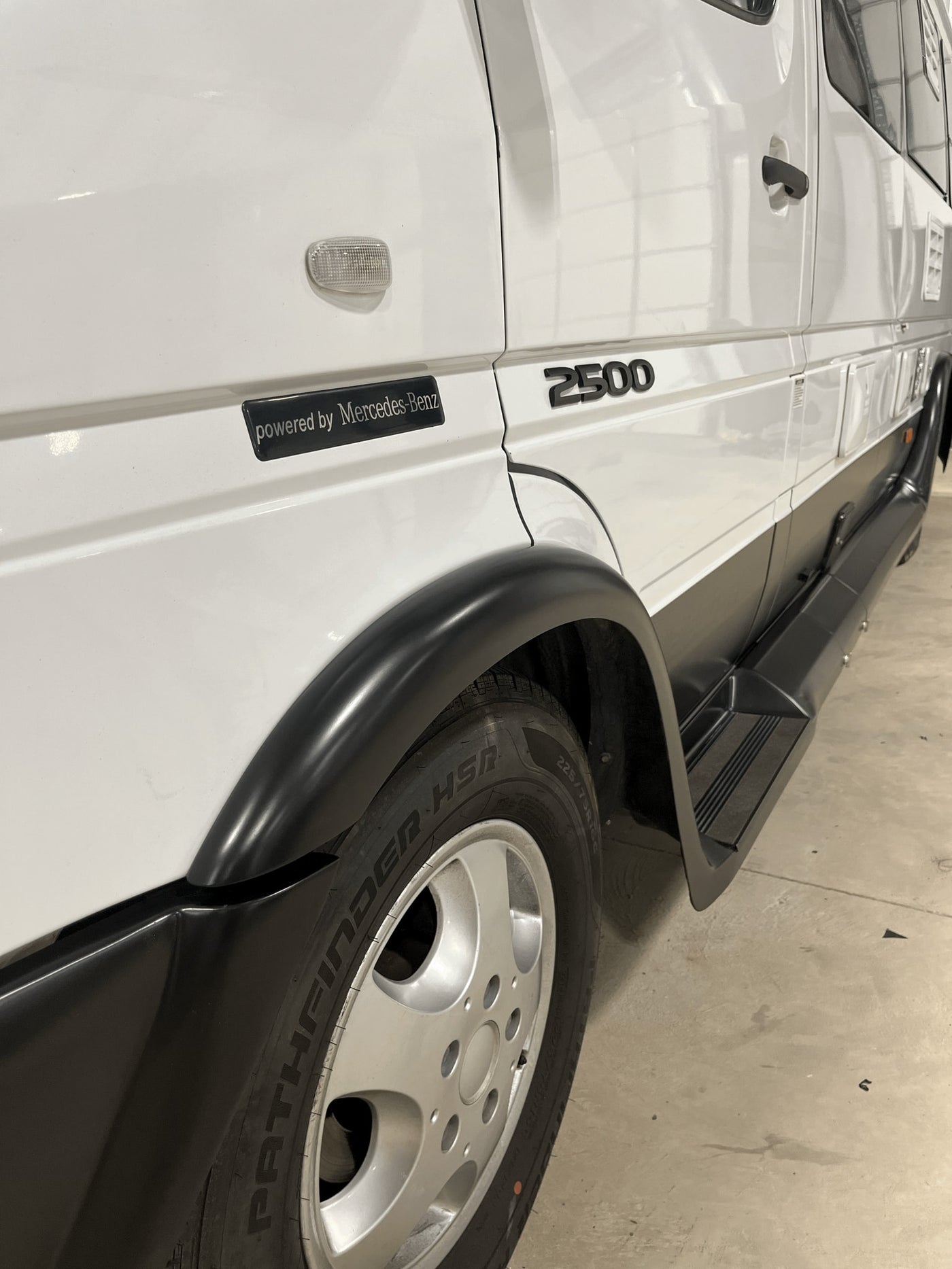White Mercedes-Benz Sprinter 2500 van, ready for rv rental. Features black fender flares, running boards, and Pathfinder HSR tires. — photo 10