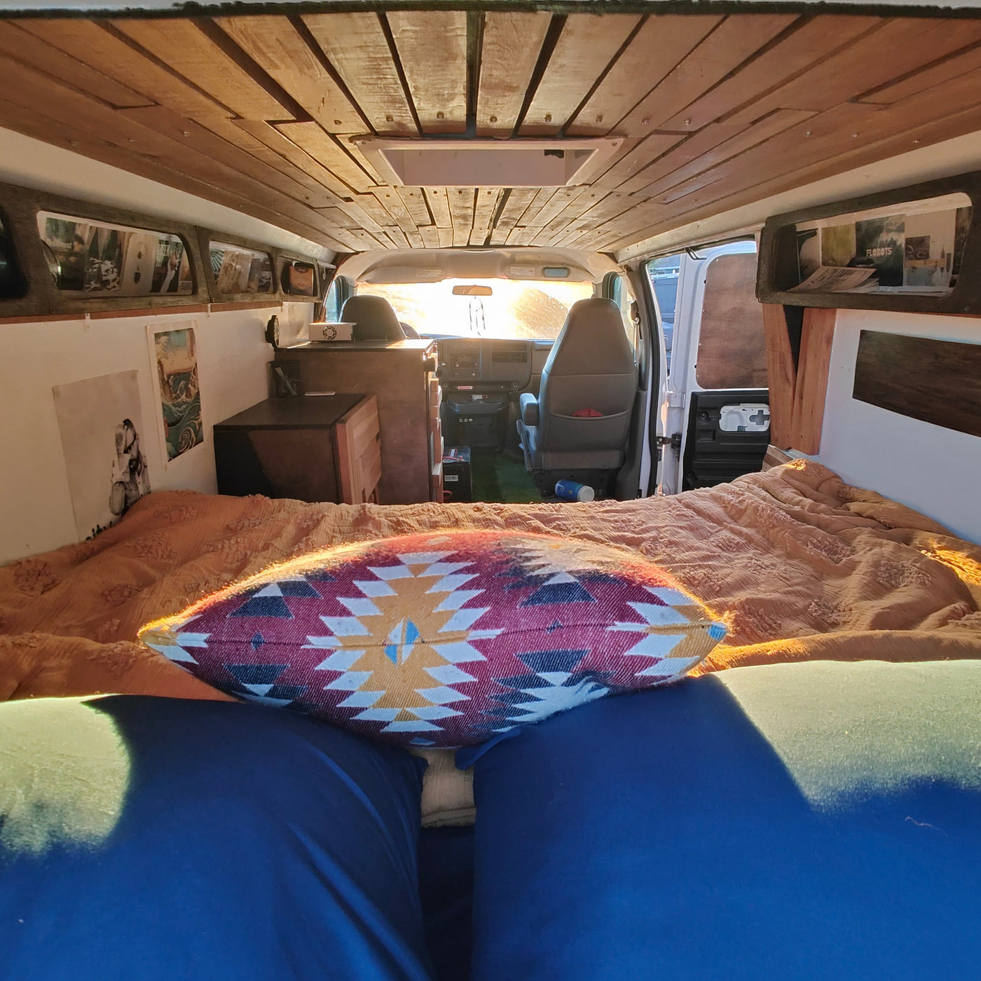 Cozy custom camper van interior featuring a patterned pillow on the bed, looking towards the front cabin. Perfect for RV rental. — photo 3