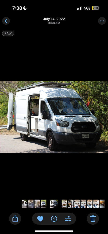 Explore with this Ford Transit camper van, available for RV rental. White exterior, open side door reveals interior. Texas PPG-4130.