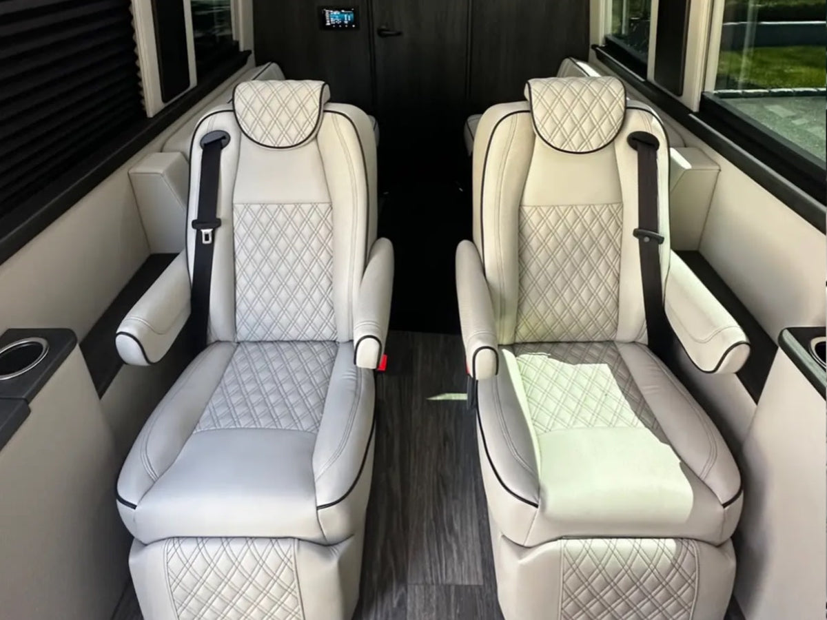  and Mercedes-Benz front cabin.|Luxurious RV rental interior featuring cream quilted captain's chairs — photo 5