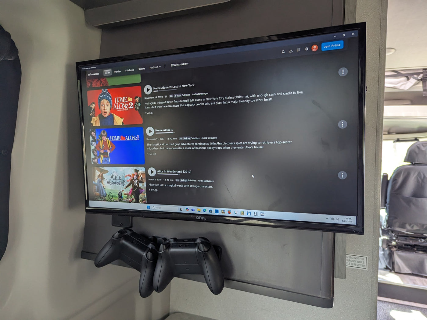 RV rental offers built-in entertainment: a TV showing Prime Video with Home Alone, plus Xbox controllers for gaming. — photo 2