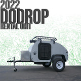 A grey 2022 DoDrop teardrop camper, an RV rental unit, shown with a roof rack and storage box, ready for adventure.