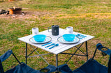 RV rental trip? Enjoy outdoor dining with a portable table set for two, cozy chairs, and a fire pit.