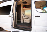 Explore this luxury RV rental interior: a custom van with plush seating and premium amenities.