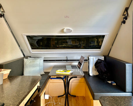 Experience comfort in this RV rental's clever interior. A laptop-ready dining area and scenic window views define this compact space.