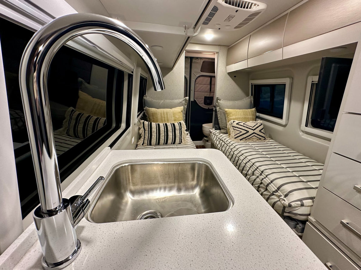  and window blinds for privacy.|Bright rv rental interior: compact kitchen — photo 8