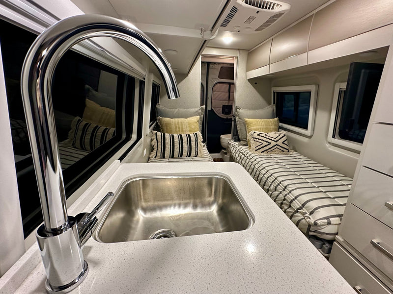  and window blinds for privacy.|Bright rv rental interior: compact kitchen — photo 8