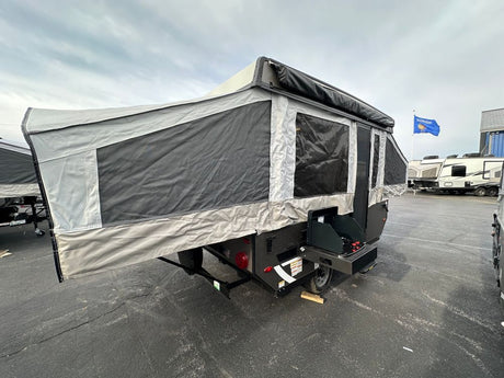 Experience camping with this pop-up camper! An excellent RV rental, it features fabric walls, windows, and an exterior grill setup.