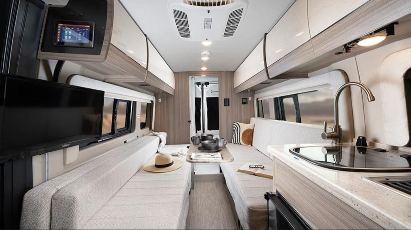  facing a mountain and ocean.|An RV rental camper van — photo 8