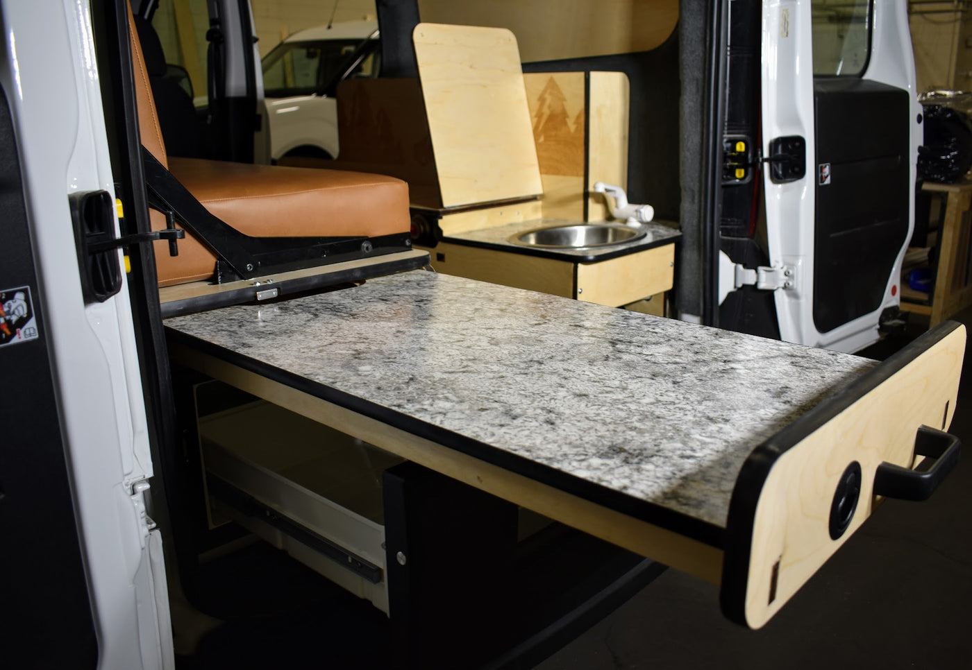 RV rental's versatile interior features a pull-out counter, compact sink, and comfortable seating. — photo 2
