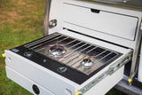 This RV rental reveals a practical pull-out two-burner gas stove with controls, ready for convenient outdoor cooking.