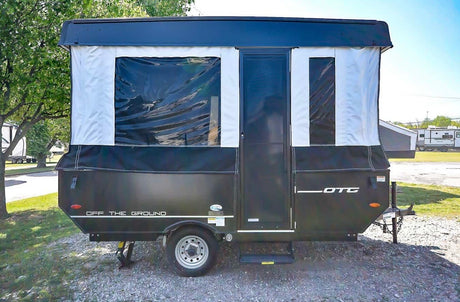 Rent this "Off The Ground" pop-up RV travel trailer. Features black & white canvas walls & clear windows.
