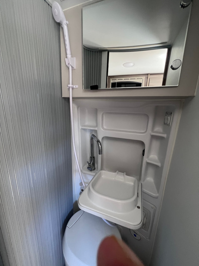  and a comfortable sleeping area with windows.|An RV rental interior shows day seating with forest views & transforms into a cozy bed for amazing stargazing.|This RV rental interior features safety controls — photo 18