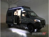 This dark gray Mercedes Sprinter RV rental camper van shows its open side door and illuminated interior, ready for adventure.