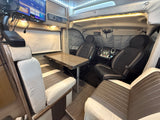 Inside a modern rv rental: dining area, infotainment system, and cockpit. Perfect for road trip adventures, a cozy camper home.